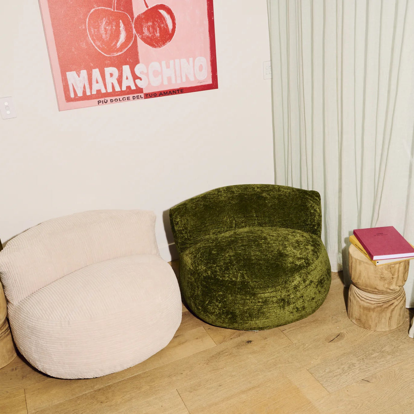 Green and beige armchairs in a room with a poster on the wall.