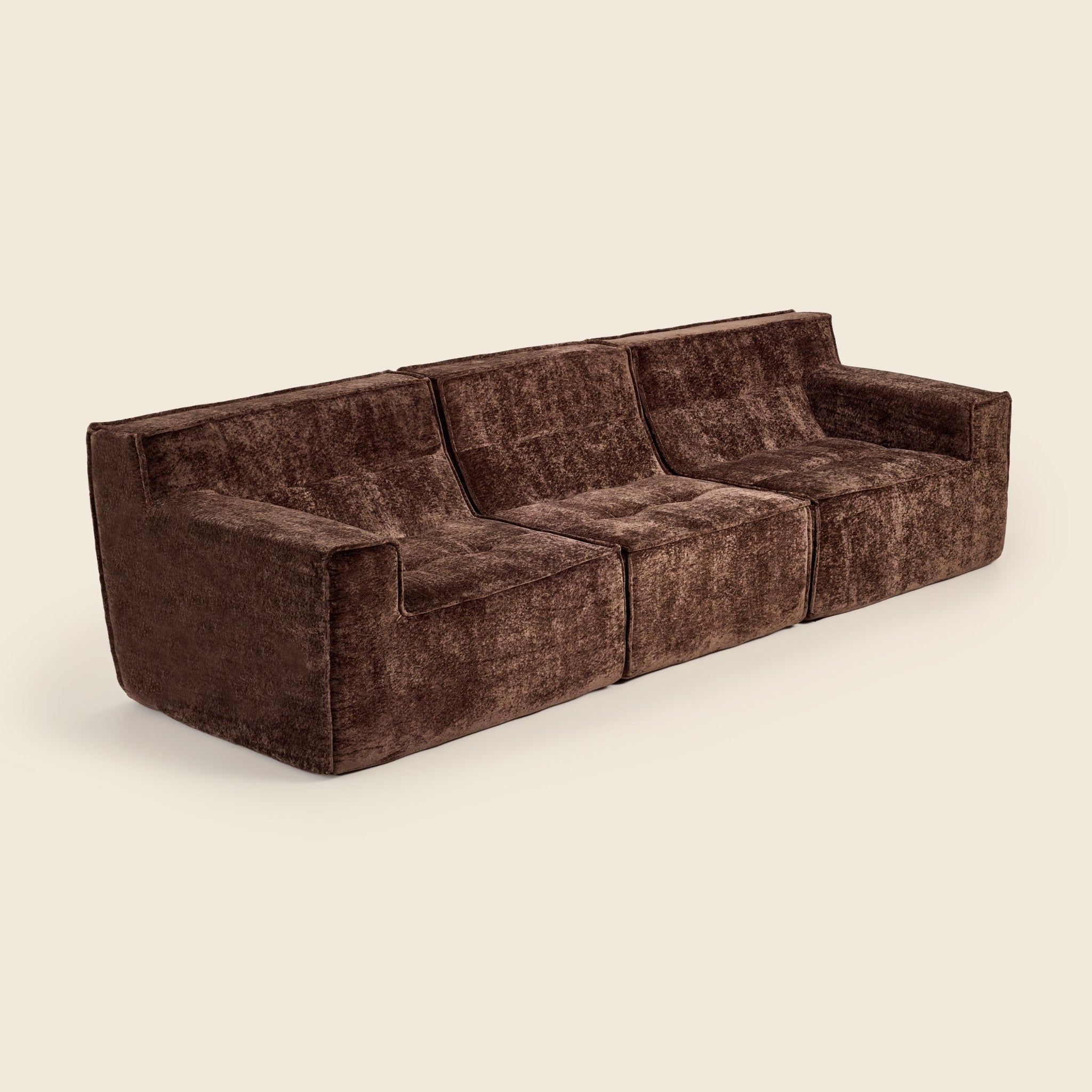 Three piece brown modular lounge on a beige background