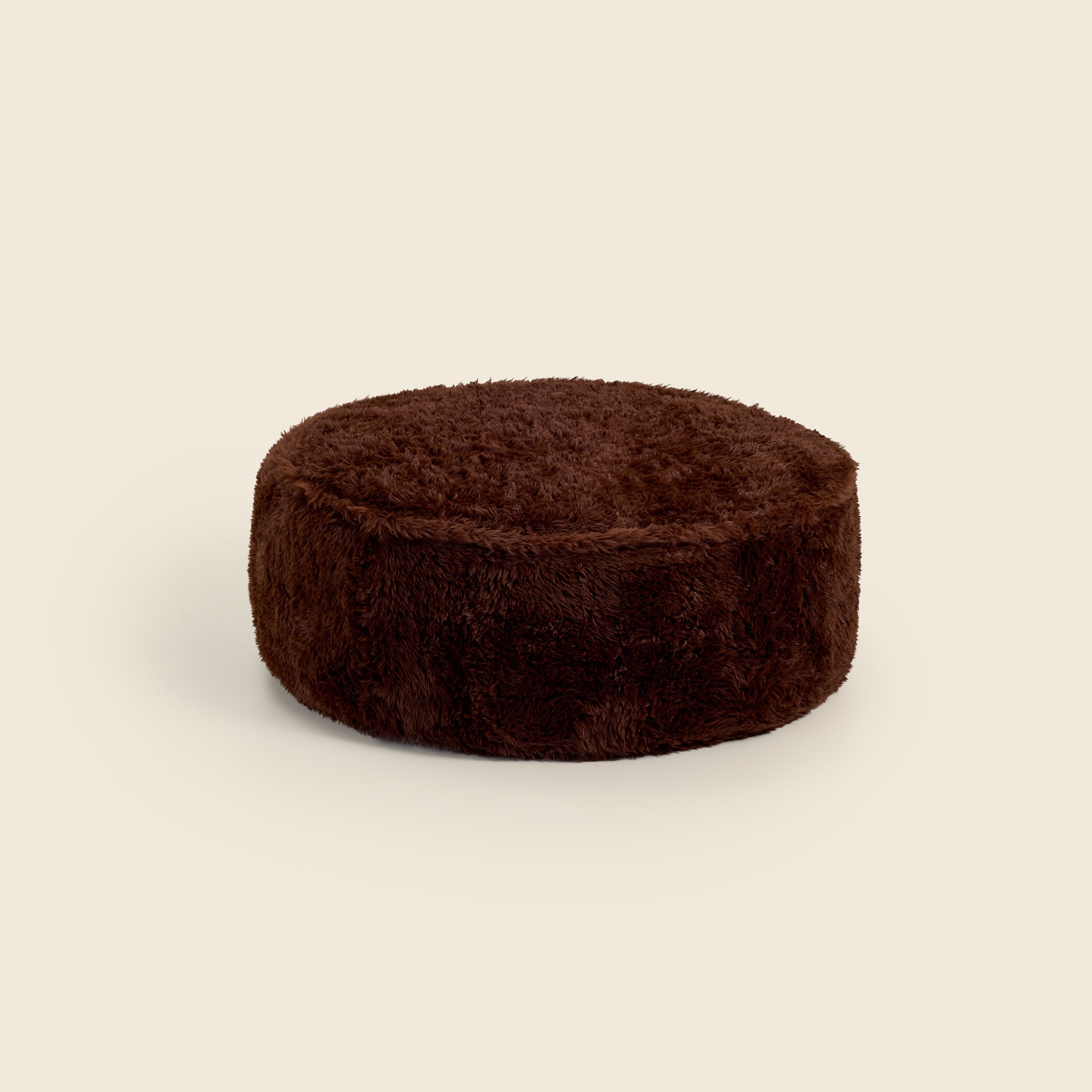 Brown round ottoman on a beige background