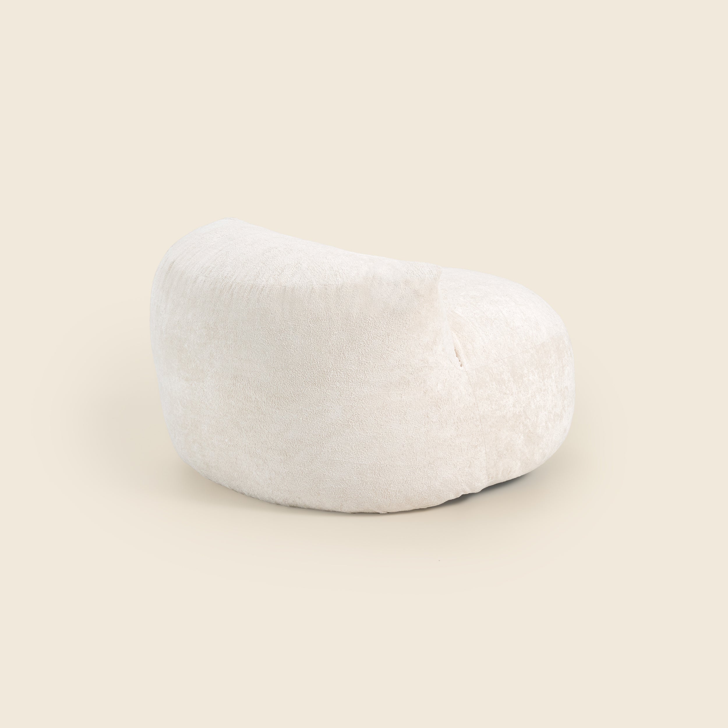 White bean bag chair on a beige background