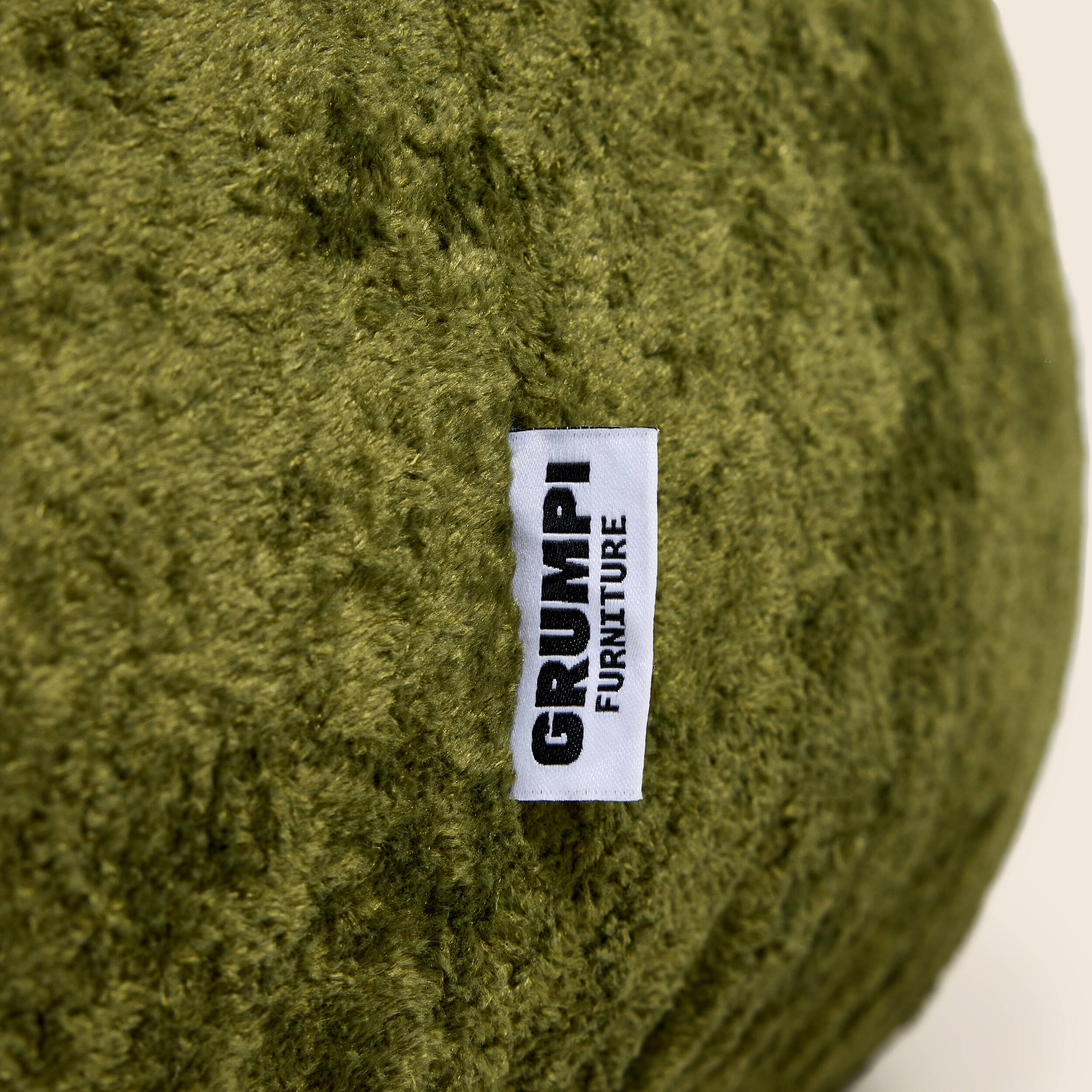 Green textured bean bag with a 'Grumpi Furniture' label.