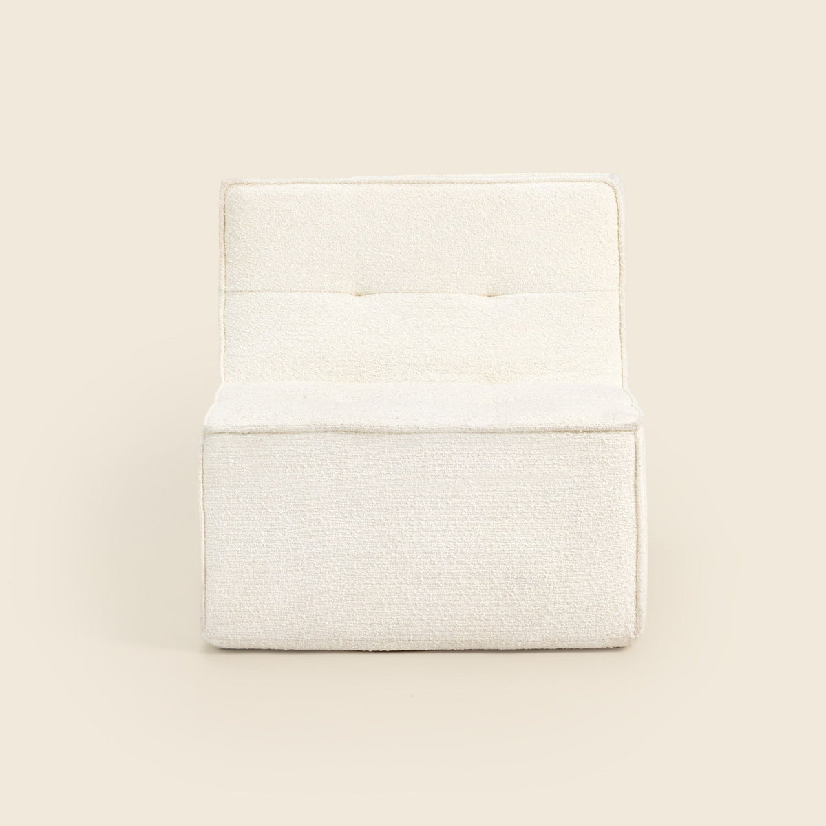 Ivory bouclé Loungi Occasional Chair, angled view on a beige background