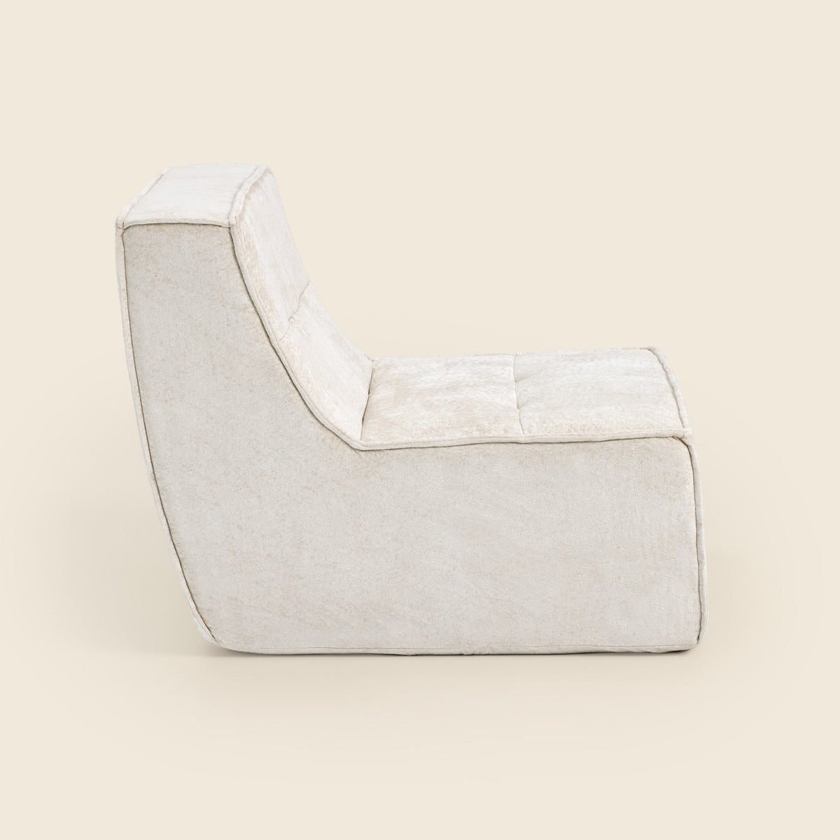 Oat snow velvet Loungi Occasional Chair, side view on a beige background