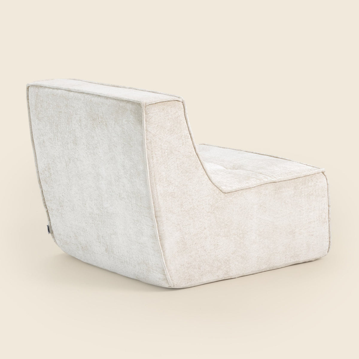 Oat snow velvet Loungi Occasional Chair on a beige background