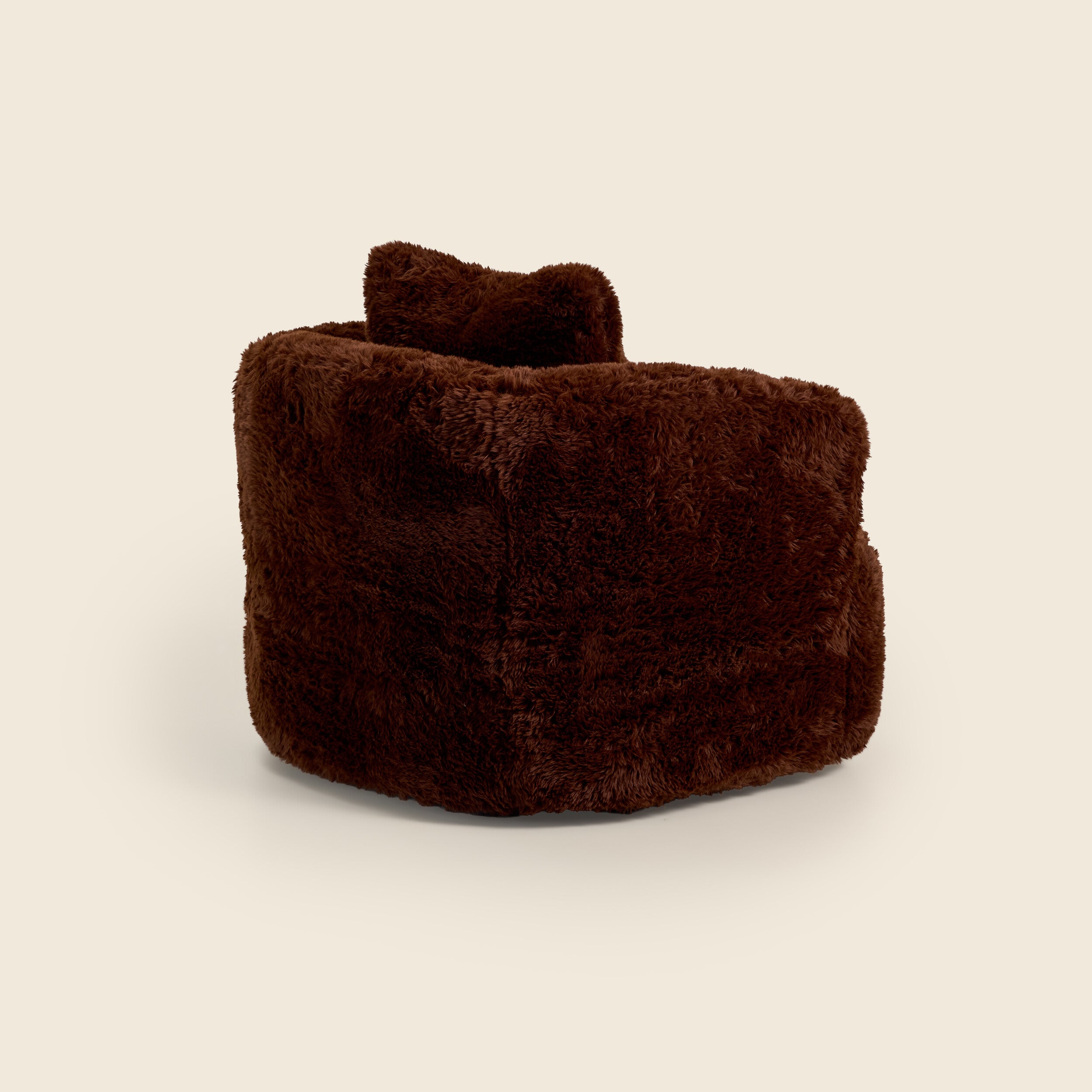 Brown plush armchair on a beige background