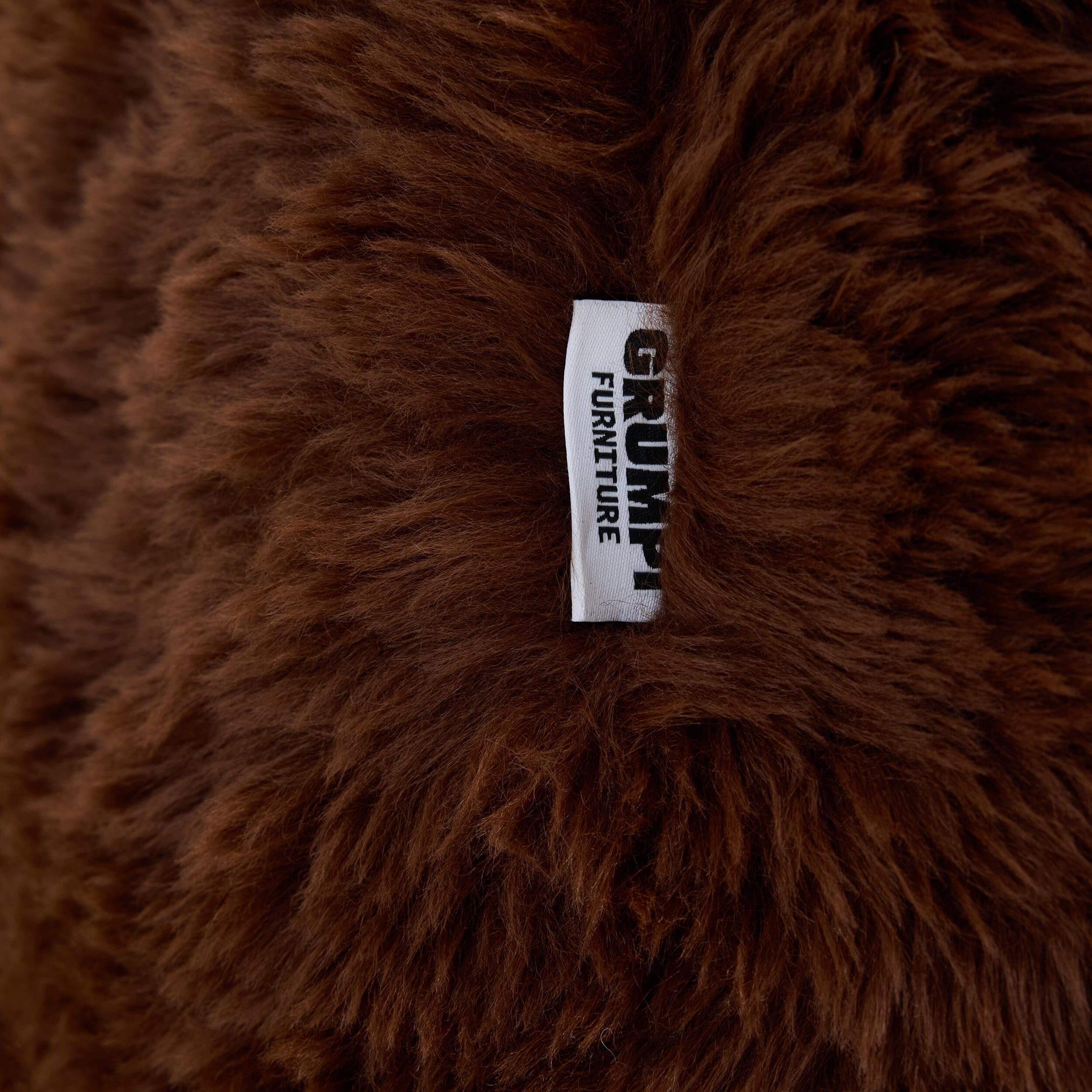 Brown plush fabric with Grumpi tag