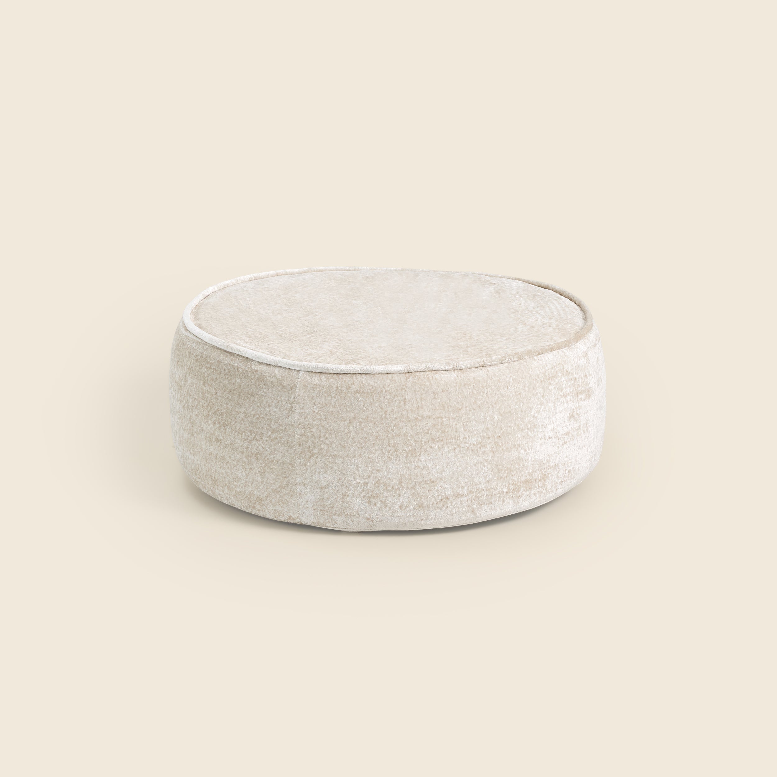 White ottoman on a beige background