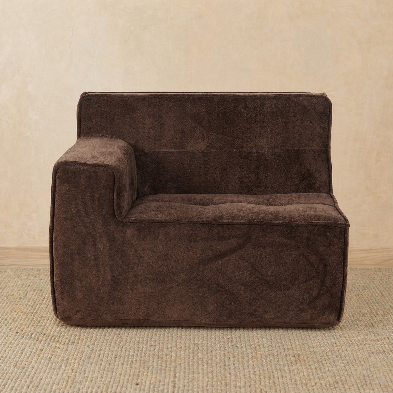 Brown sofa against a beige wall