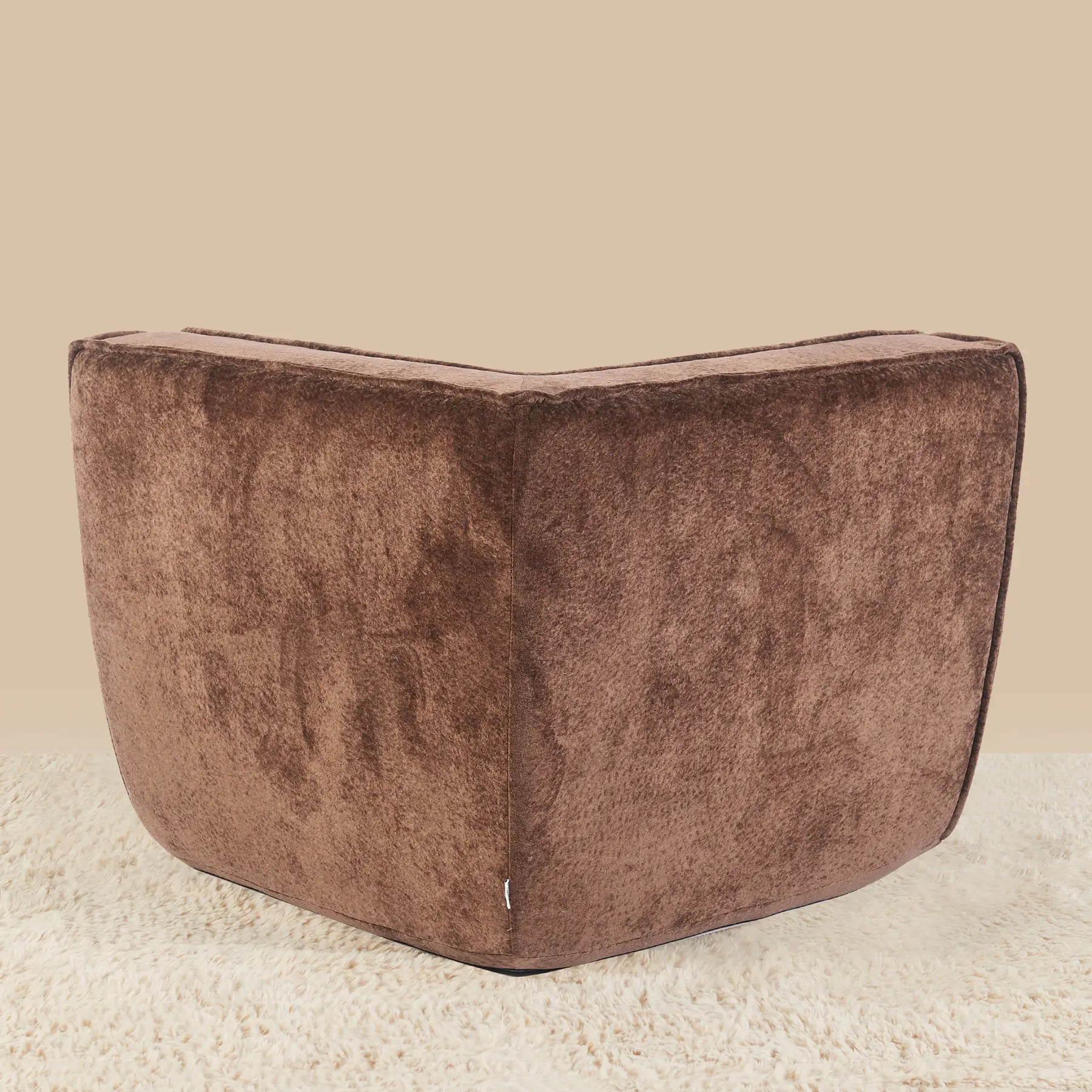 Brown textured ottoman on a beige carpet with a beige wall background
