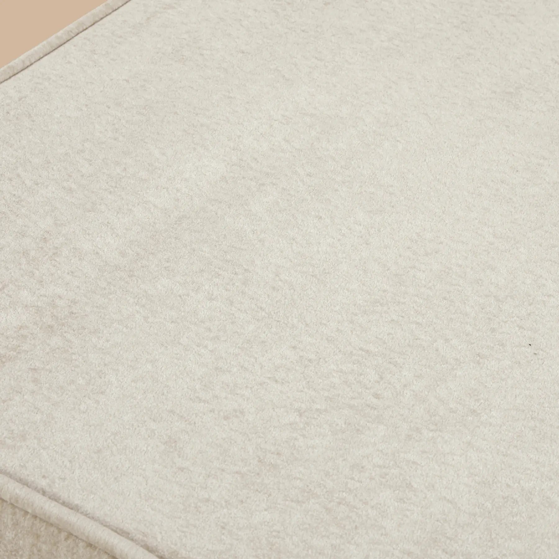 Close-up of a textured beige fabric surface