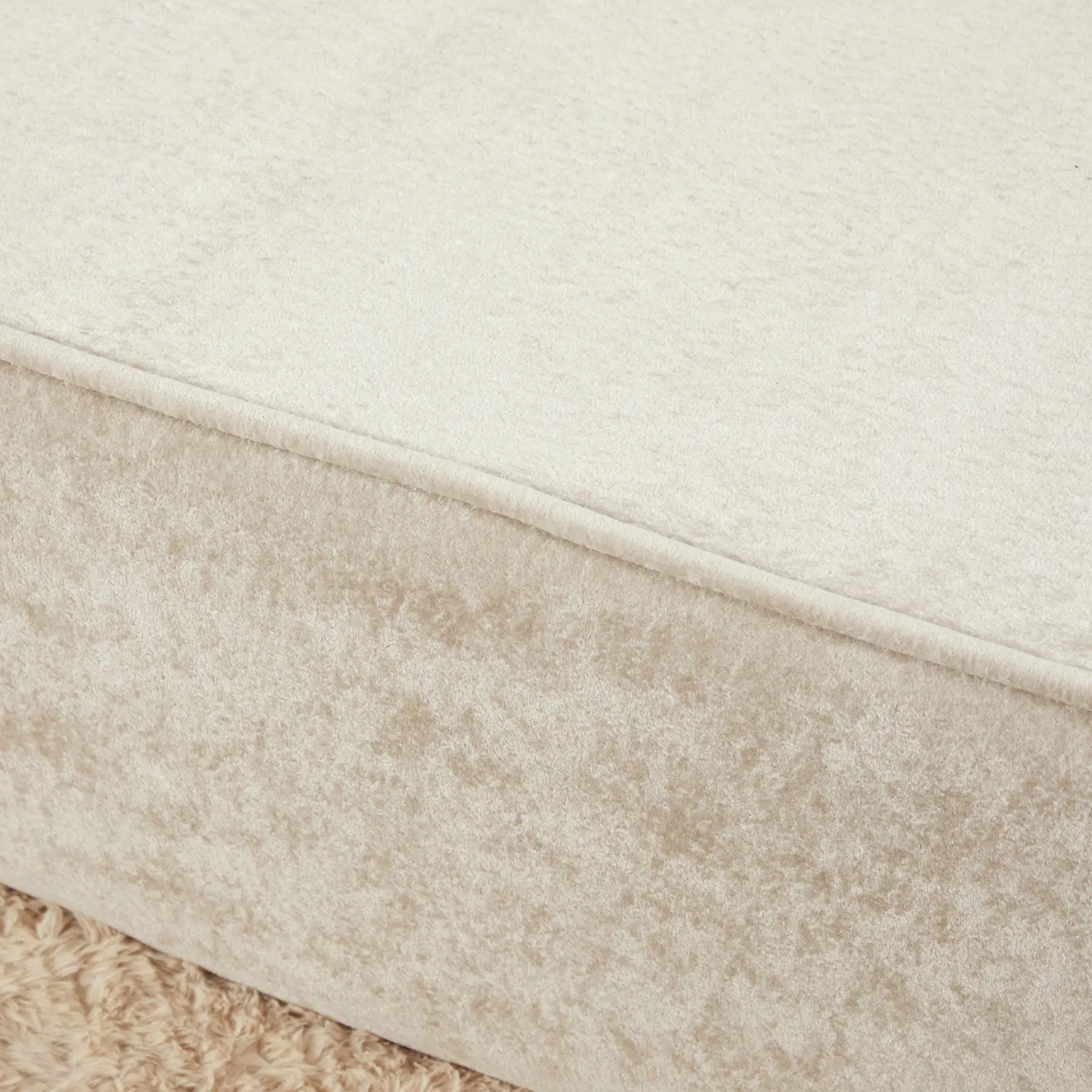 Close-up of a textured fabric with a gradient from beige to white.