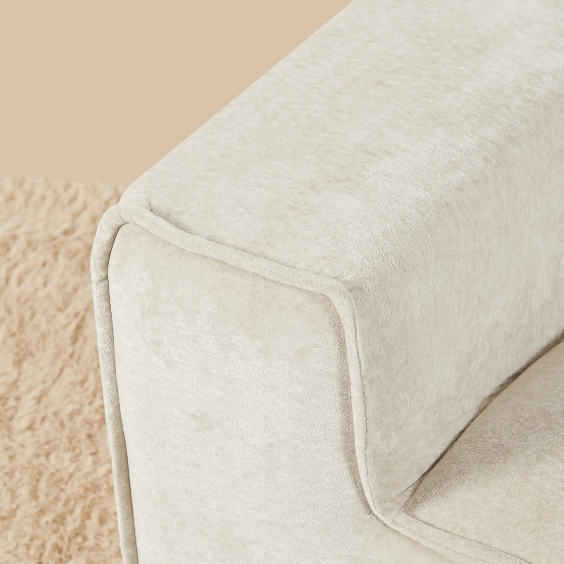 Close-up of a textured beige blanket on a soft beige background