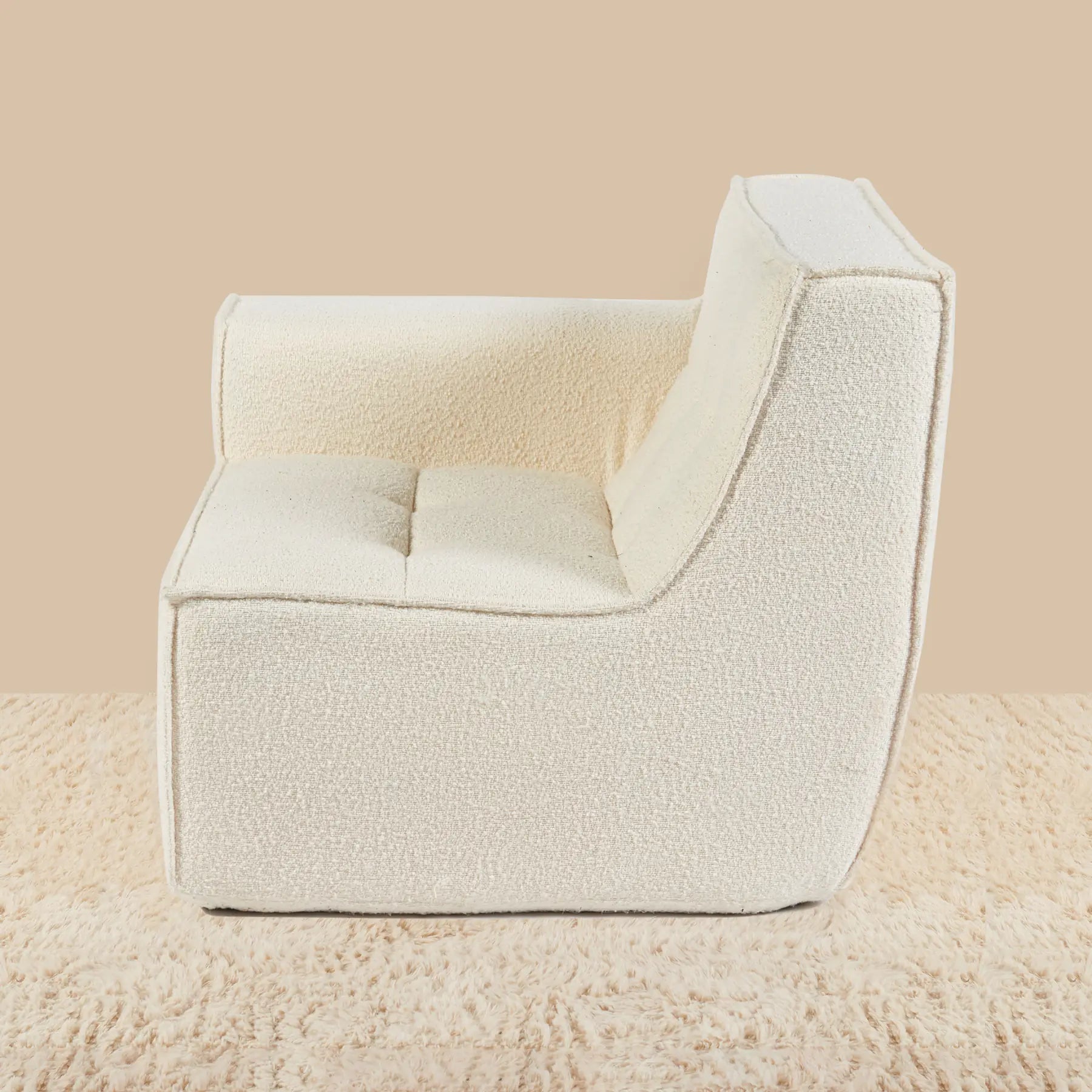 Cream-colored armchair on a matching beige background