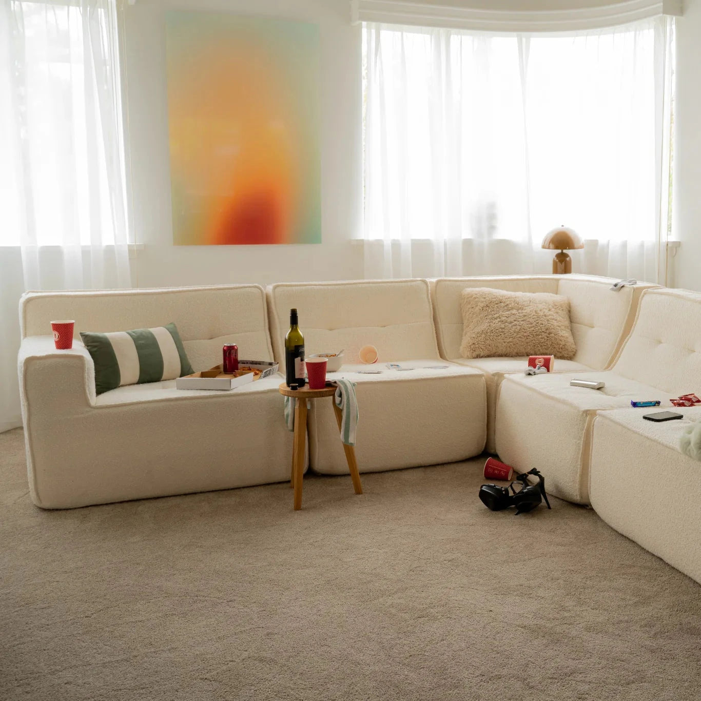 Living room with a beige sectional sofa, small table, and decorative items.