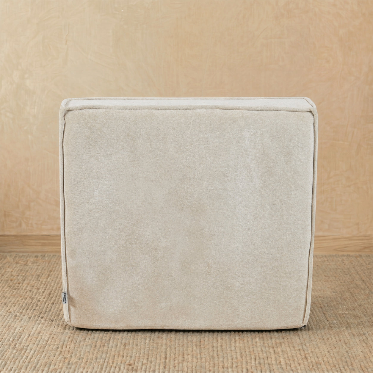 Beige fabric cube on a beige background