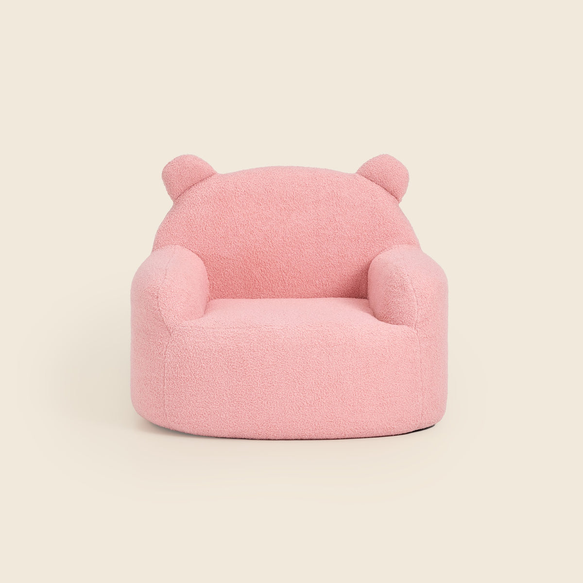 Pink Teddi Kids Armchair with teddy bear ears, front view on a beige background