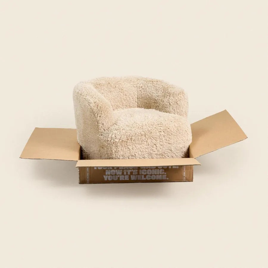 A cream Grumpi chair puffed up in its open box