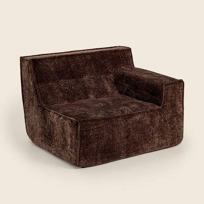 Brown textured armchair on a beige background
