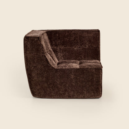 Brown textured armchair on a beige background
