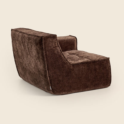 Brown textured armchair on a beige background
