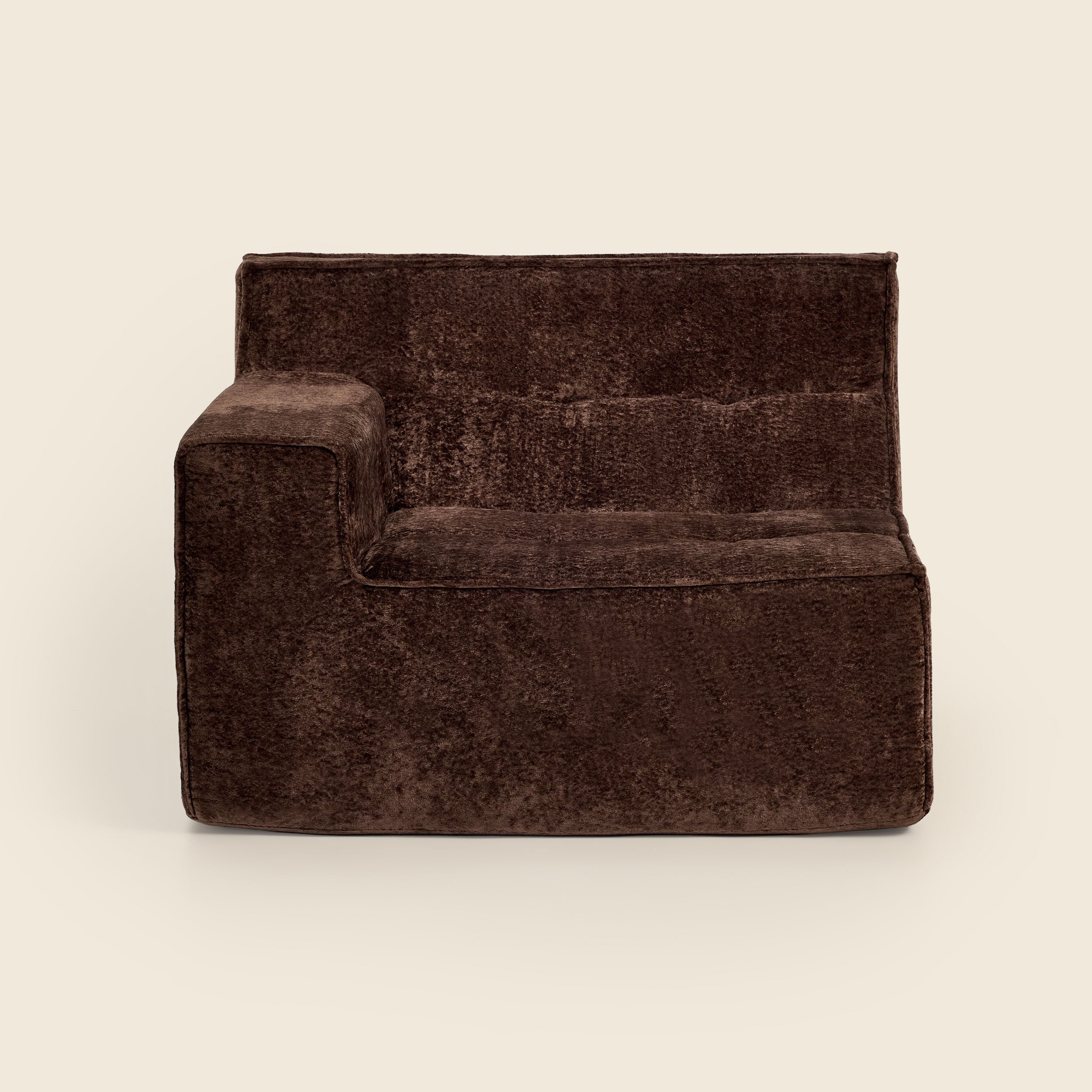 Brown velvet armchair on a beige background

