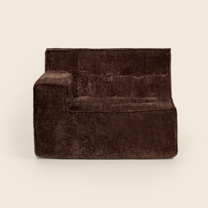Brown velvet armchair on a beige background

