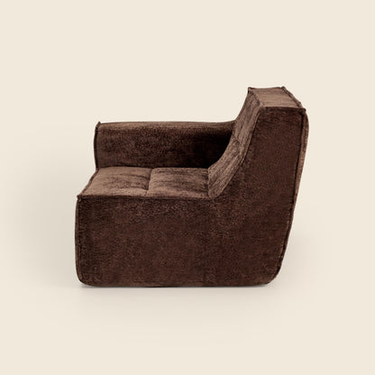 Brown upholstered chair on a beige background

