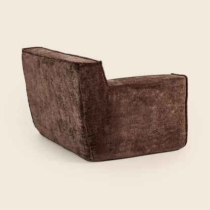 Brown textured armchair on a beige background
