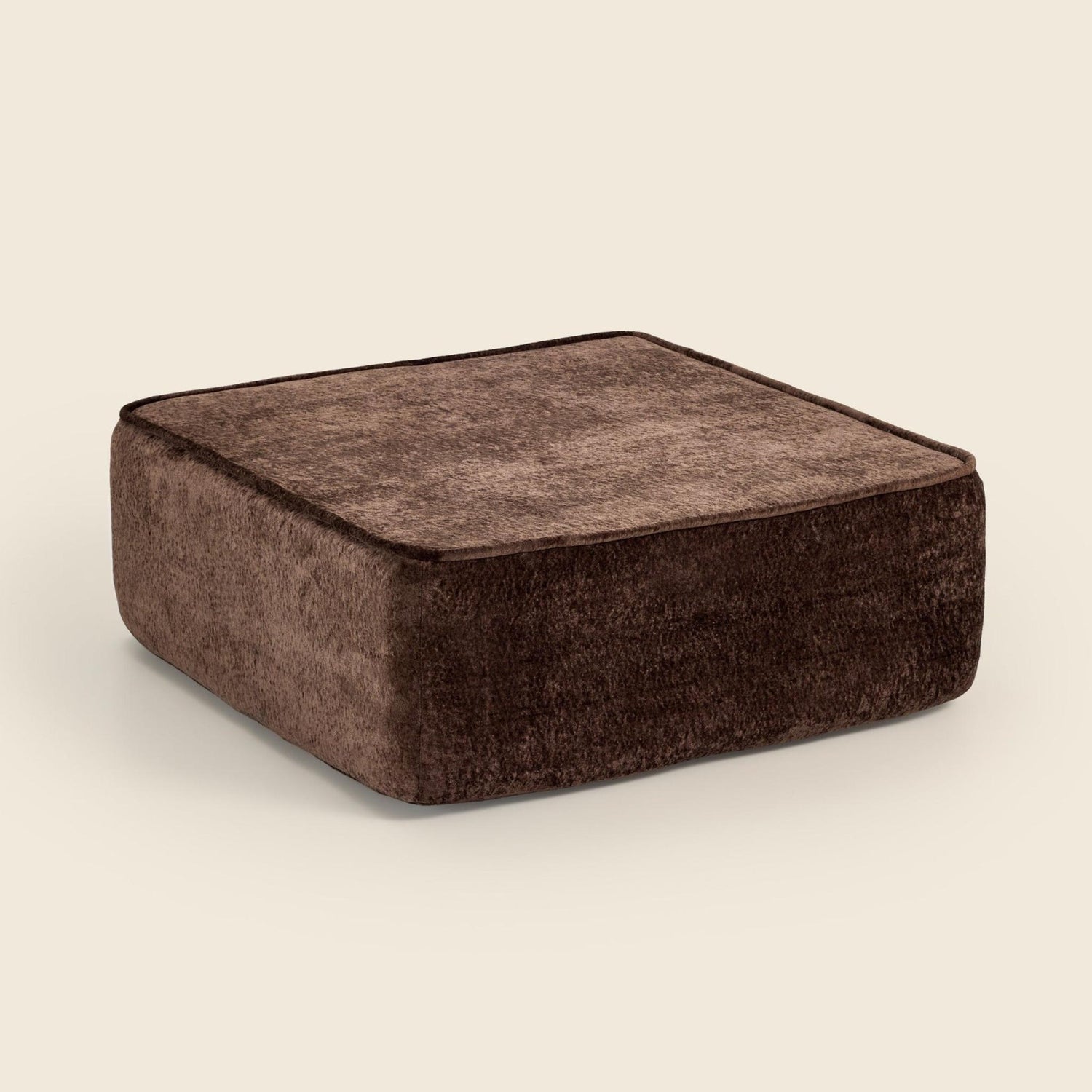 Brown textured square ottoman on a beige background. #color_brown-snow-velvet