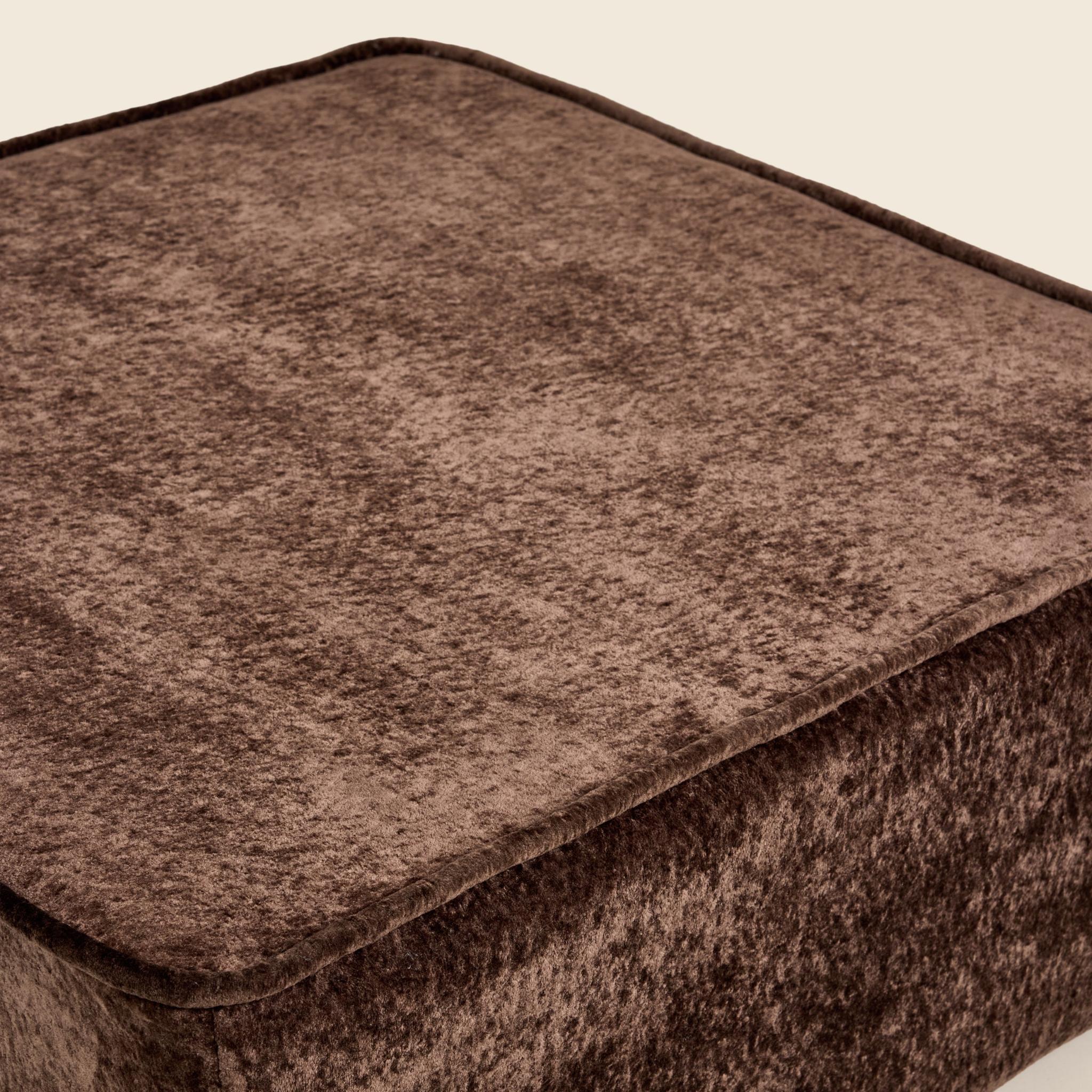 Close up of brown textured ottoman on a beige background
