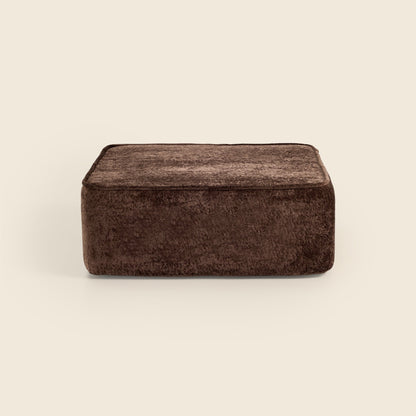 Brown textured ottoman on a beige background
