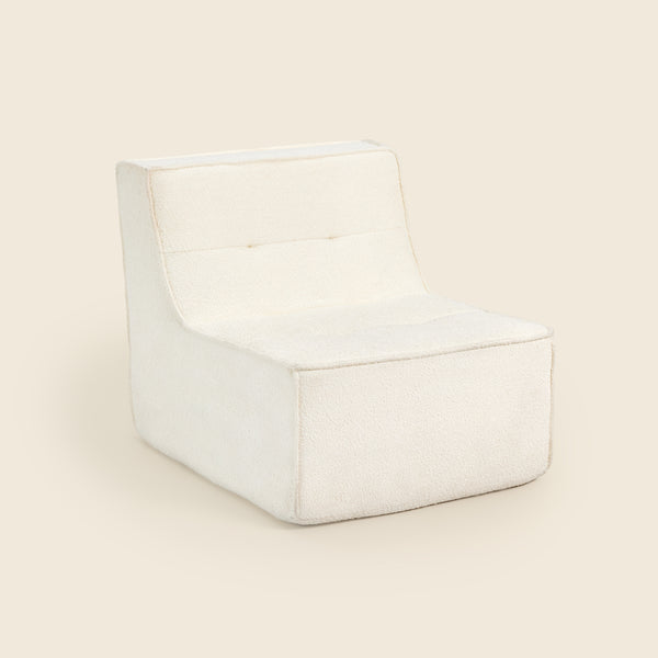 Ivory boucle Loungi modular chair on a beige background #color_ivory-boucle