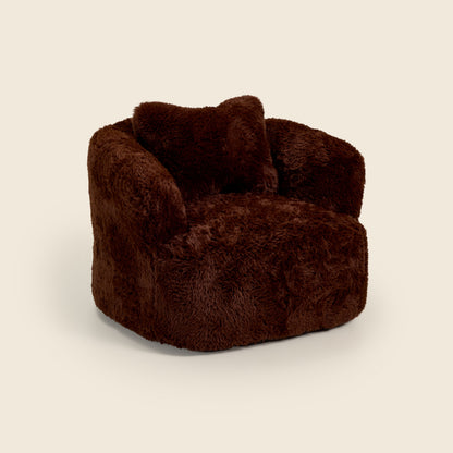 Brown fluffy armchair on a beige background 