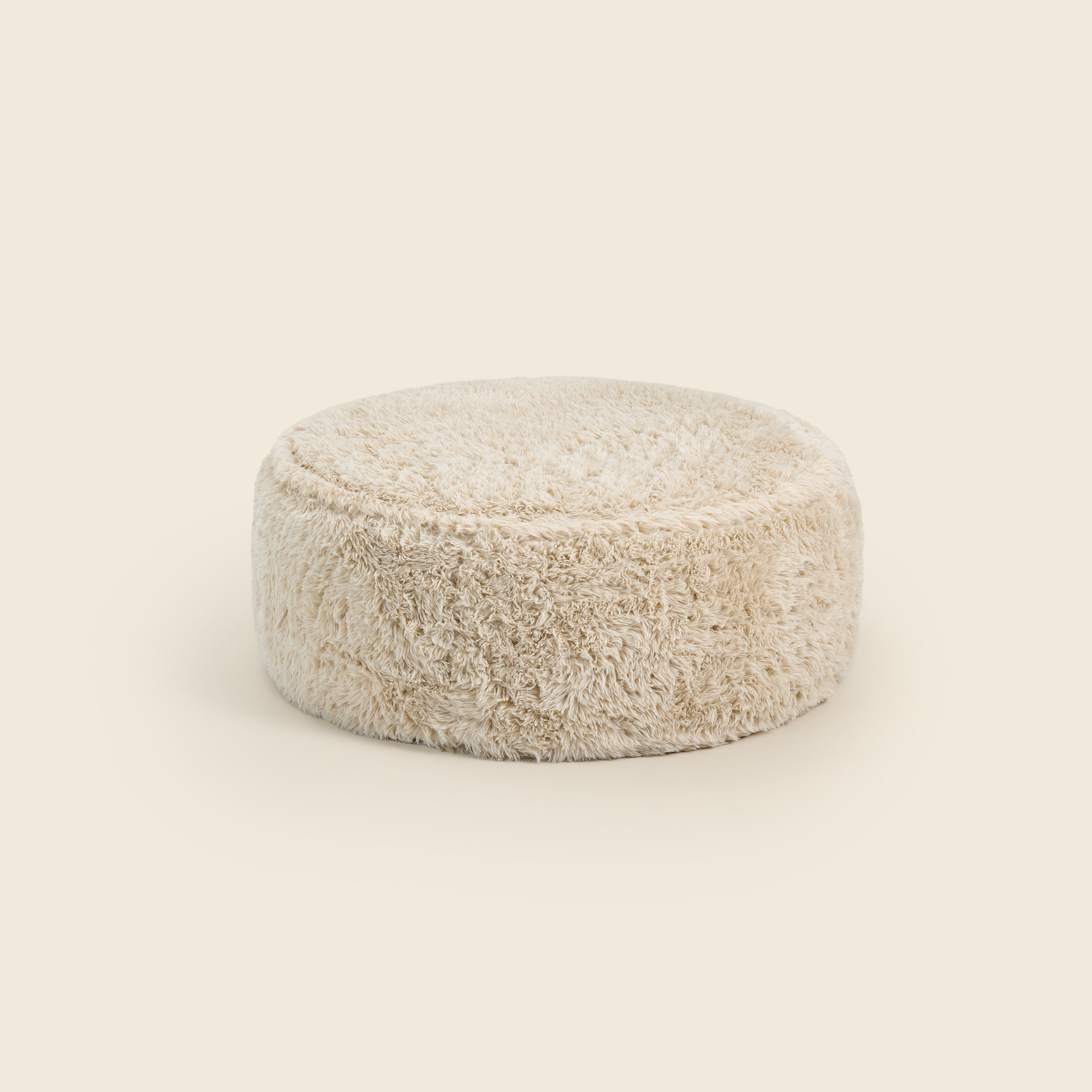 Round beige pouf on a beige background
#color_cream-faux-fur