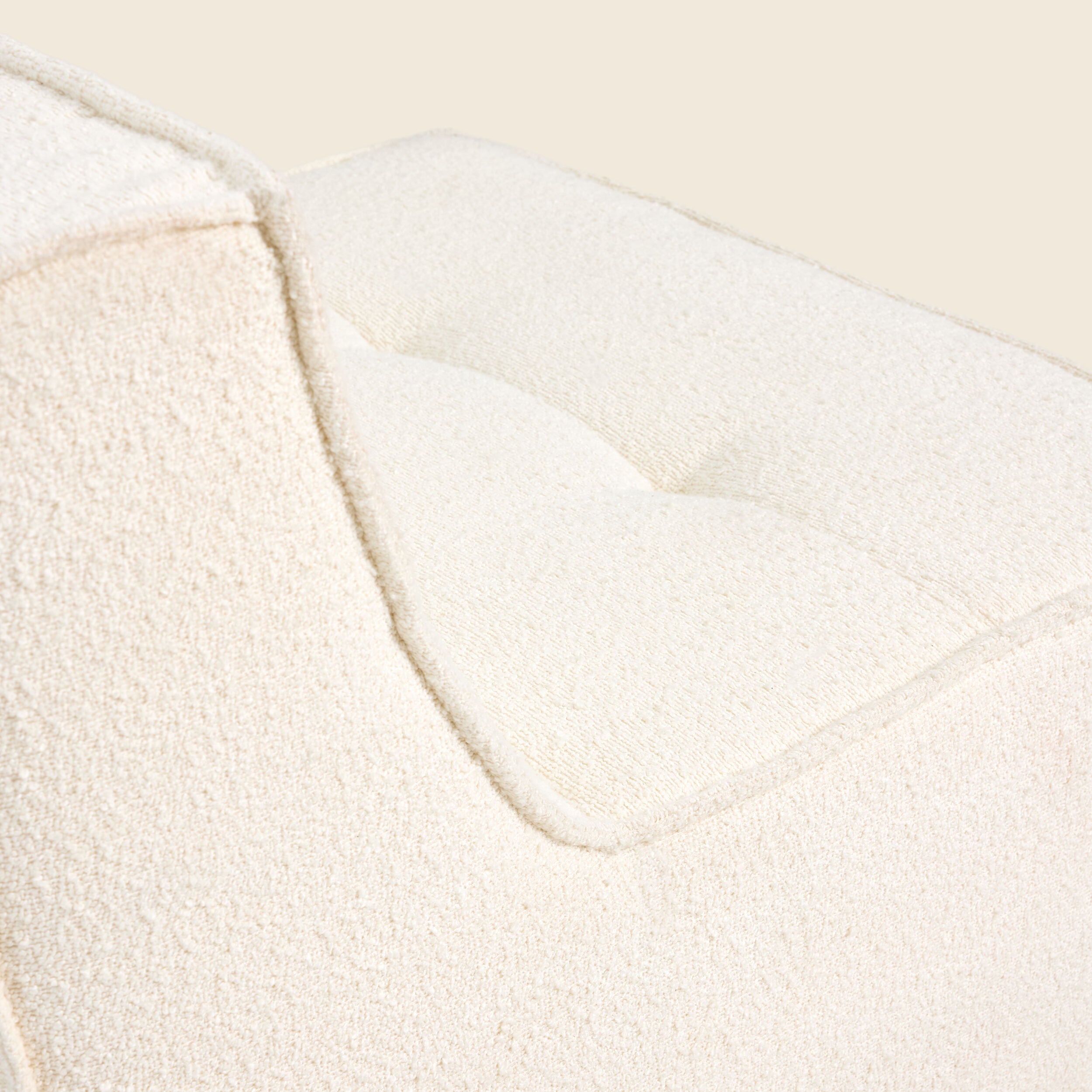 Close-up of ivory boucle fabric on the Loungi modular chair 
