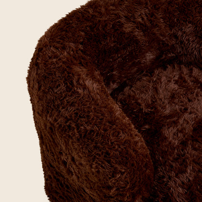 Close-up of a brown, fluffy chair on a beige background

