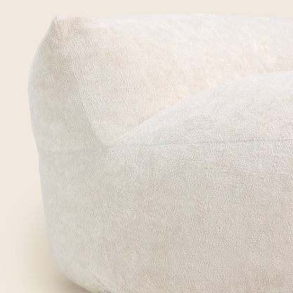 White bean bag chair on a beige background 