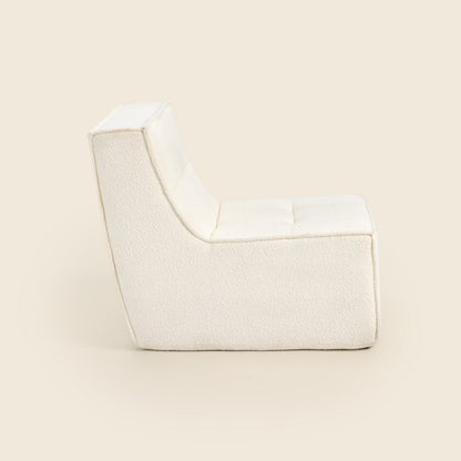 Ivory boucle Loungi modular chair, side view on a beige background 