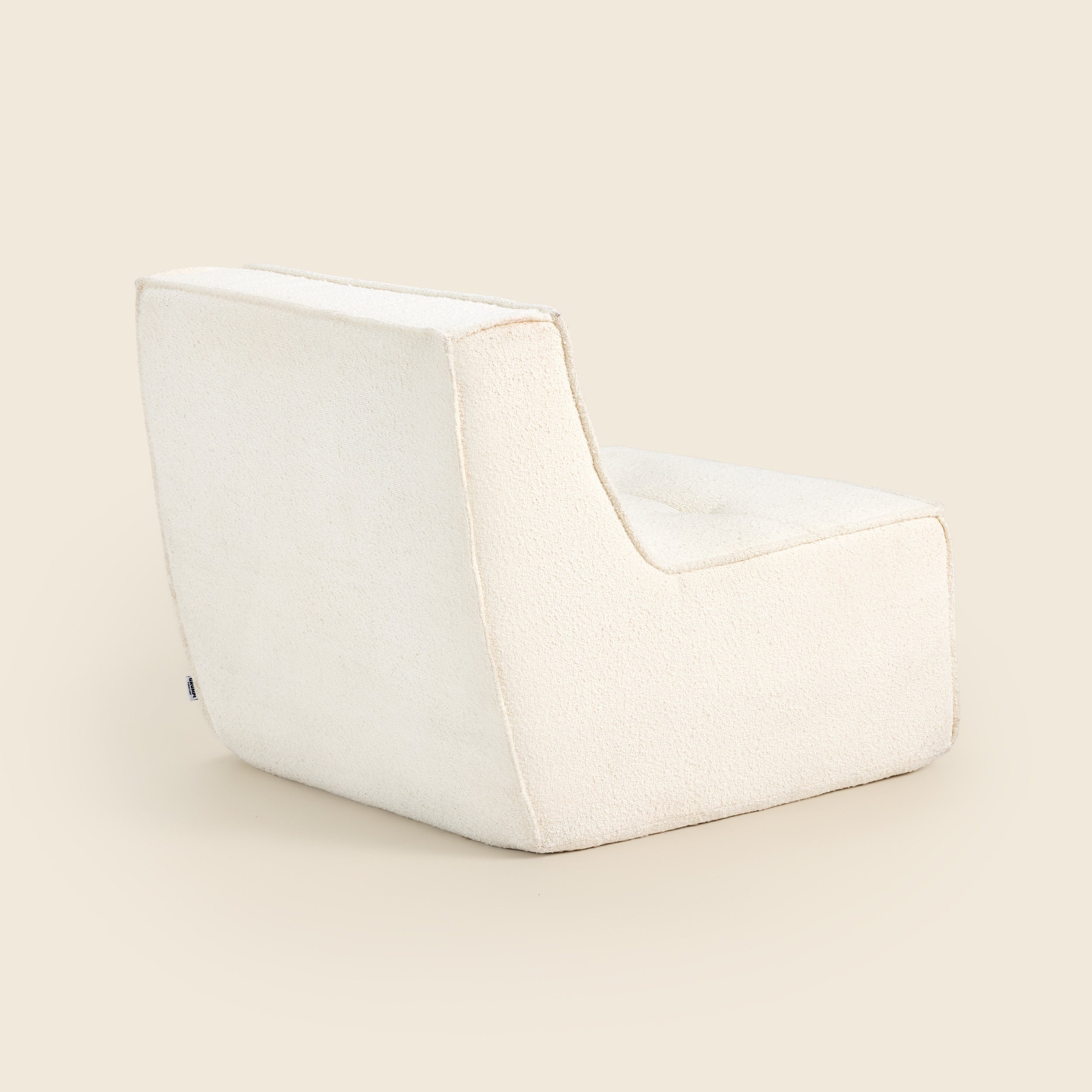 Ivory boucle Loungi modular chair on a beige background 