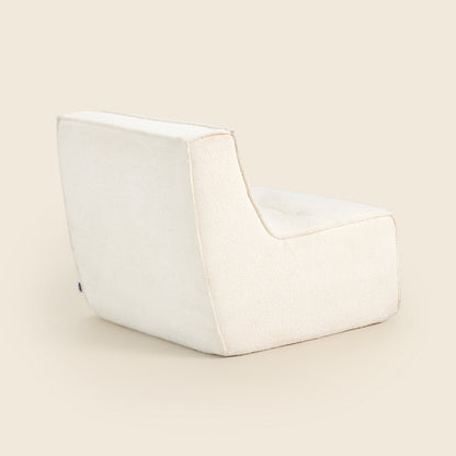 Ivory boucle Loungi modular chair on a beige background 