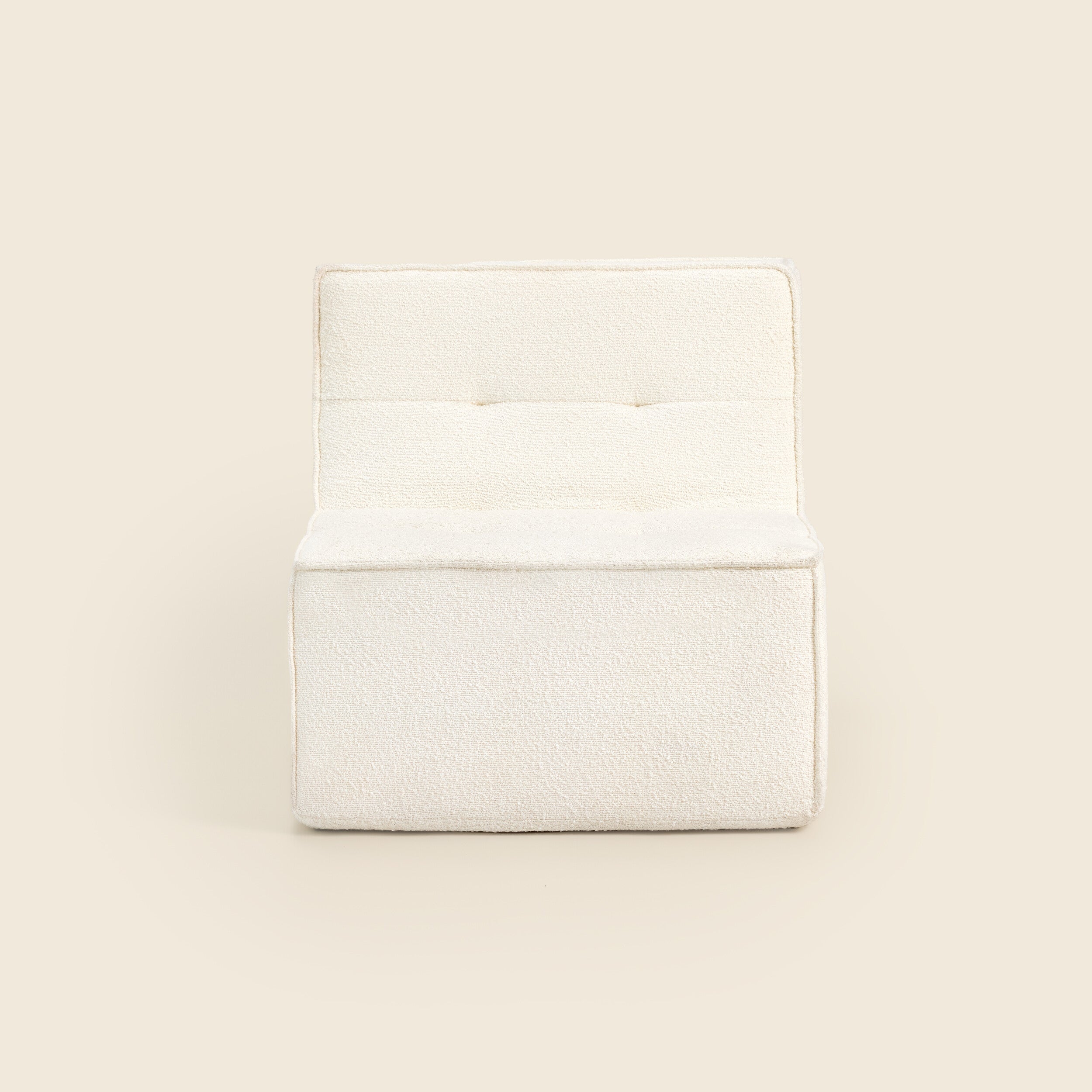 Ivory boucle Loungi modular chair, angled view on a beige background 