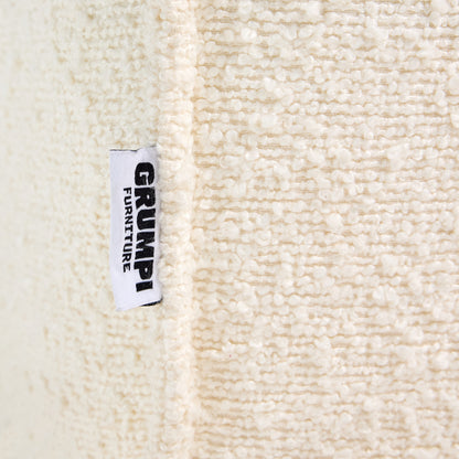 Ivory boucle Loungi modular chair detail on a beige background 