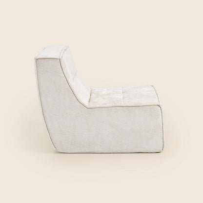 Oat snow velvet Loungi modular chair, side view on a beige background 