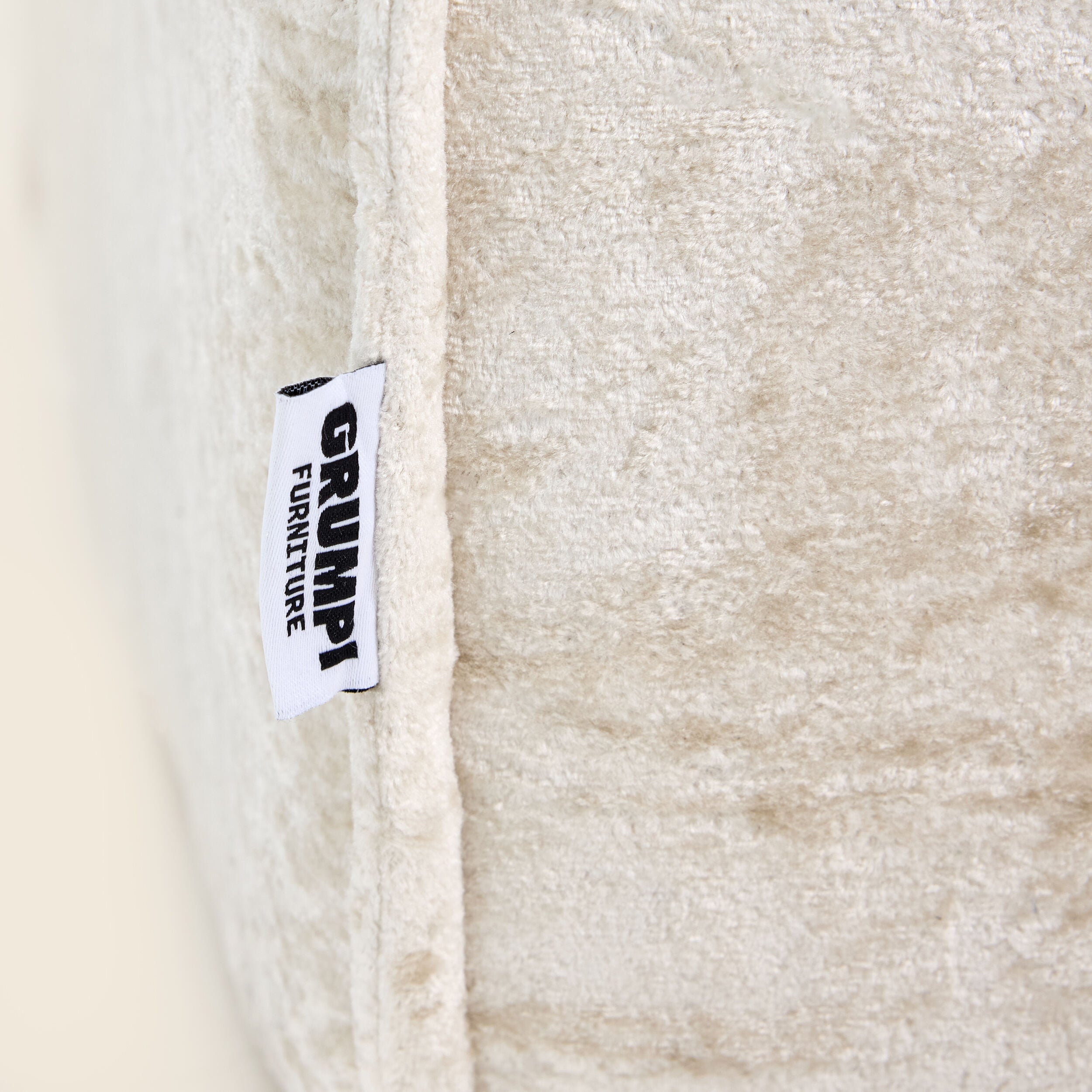 Oat snow velvet Loungi modular chair detail on a beige background 