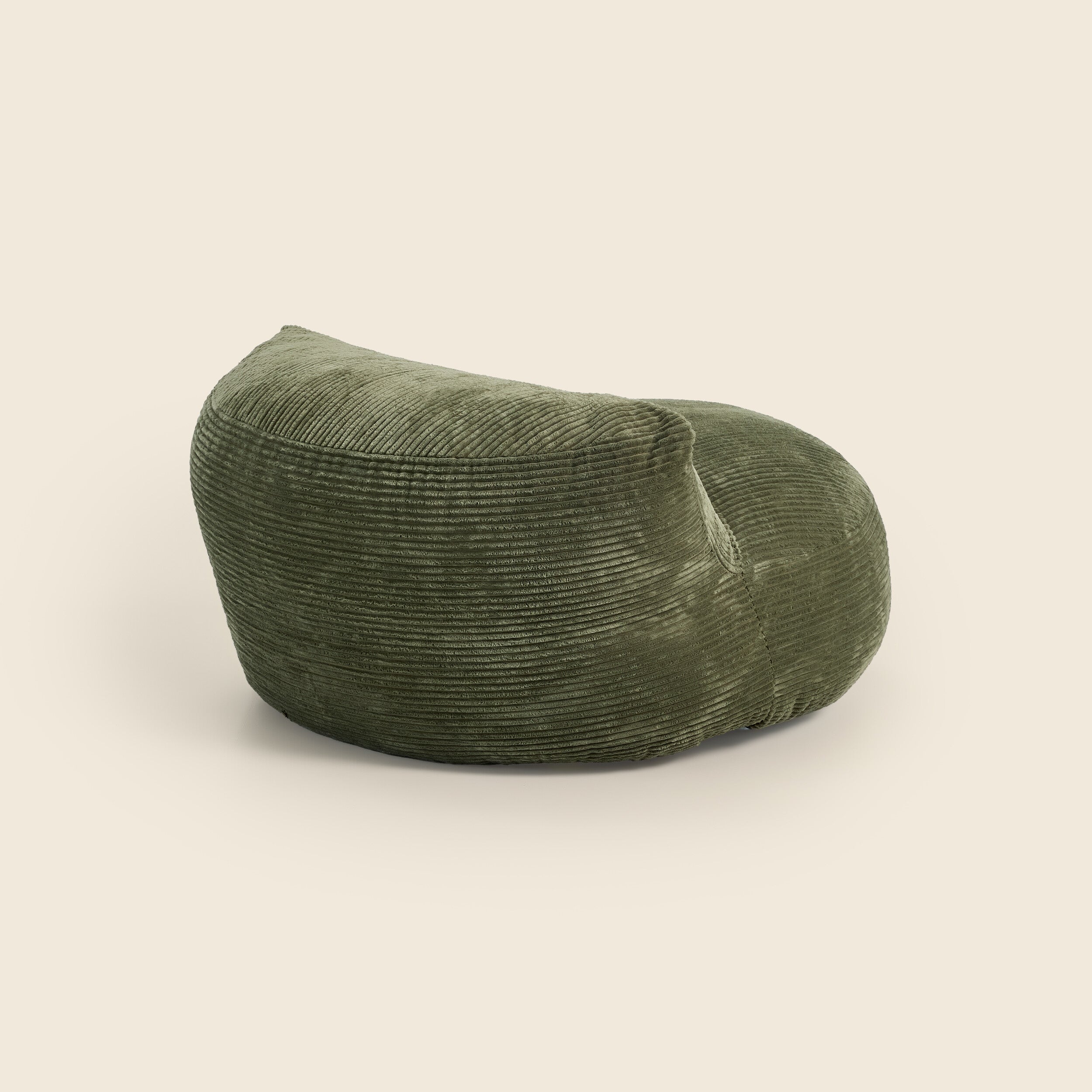 Green bean bag chair on a beige background
 