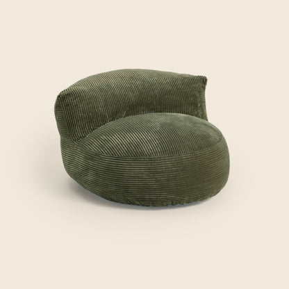 Green corduroy armchair on a beige background 