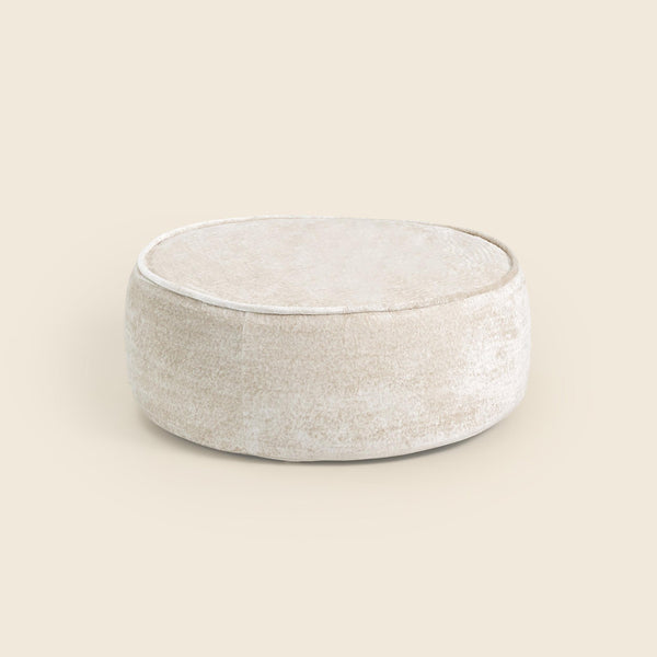Tootsi Round Ottoman in oat snow velvet on a beige background #color_oat-snow-velvet