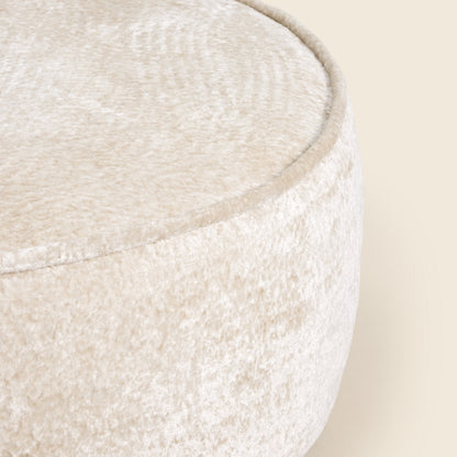 Close up of white ottoman on a beige background 