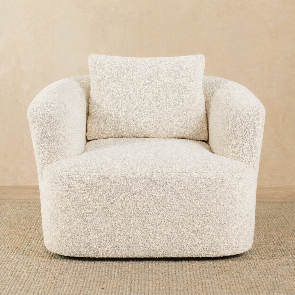 Beige armchair with a pillow on a beige background 