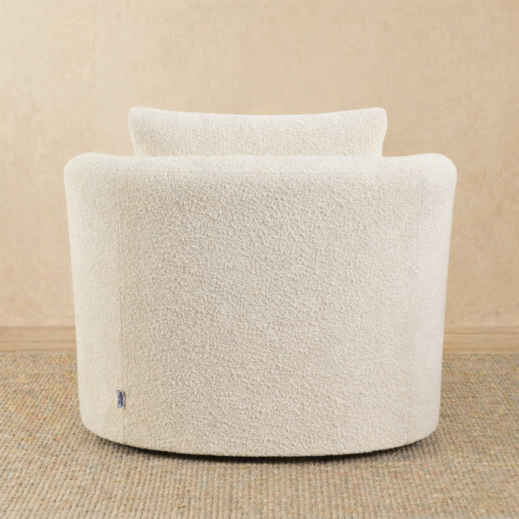 Cream-colored boucle armchair on a beige background 